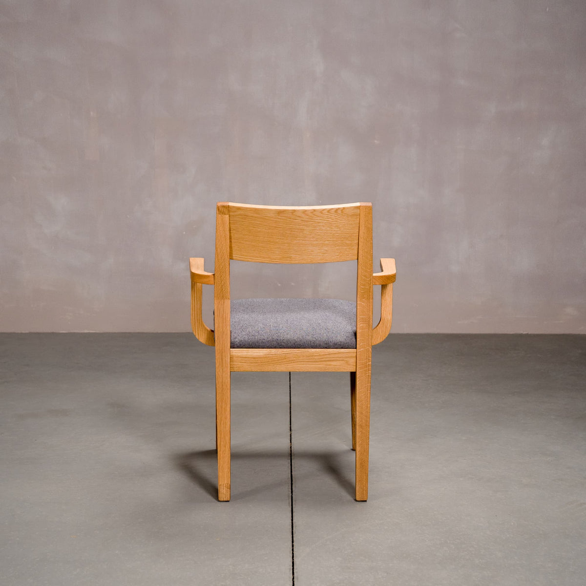a White Oak Aubrey Armchair finished in Pure D with Graphite fabric seat