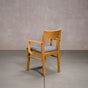 a White Oak Aubrey Armchair finished in Pure D with Graphite fabric seat