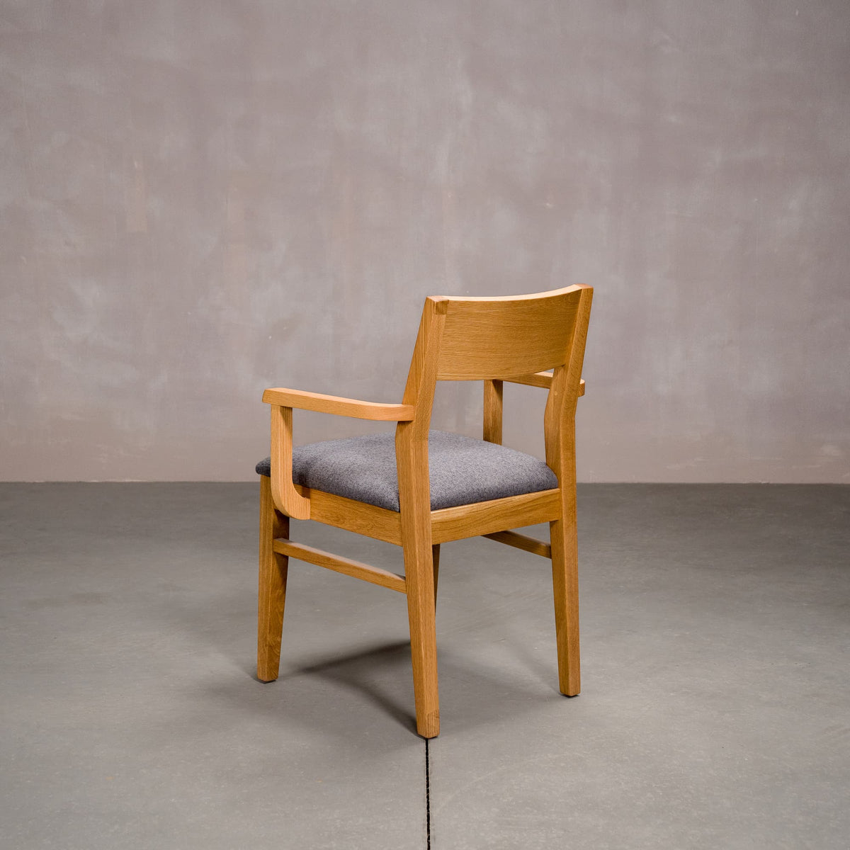 a White Oak Aubrey Armchair finished in Pure D with Graphite fabric seat