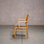 a White Oak Aubrey Armchair finished in Pure D with Graphite fabric seat