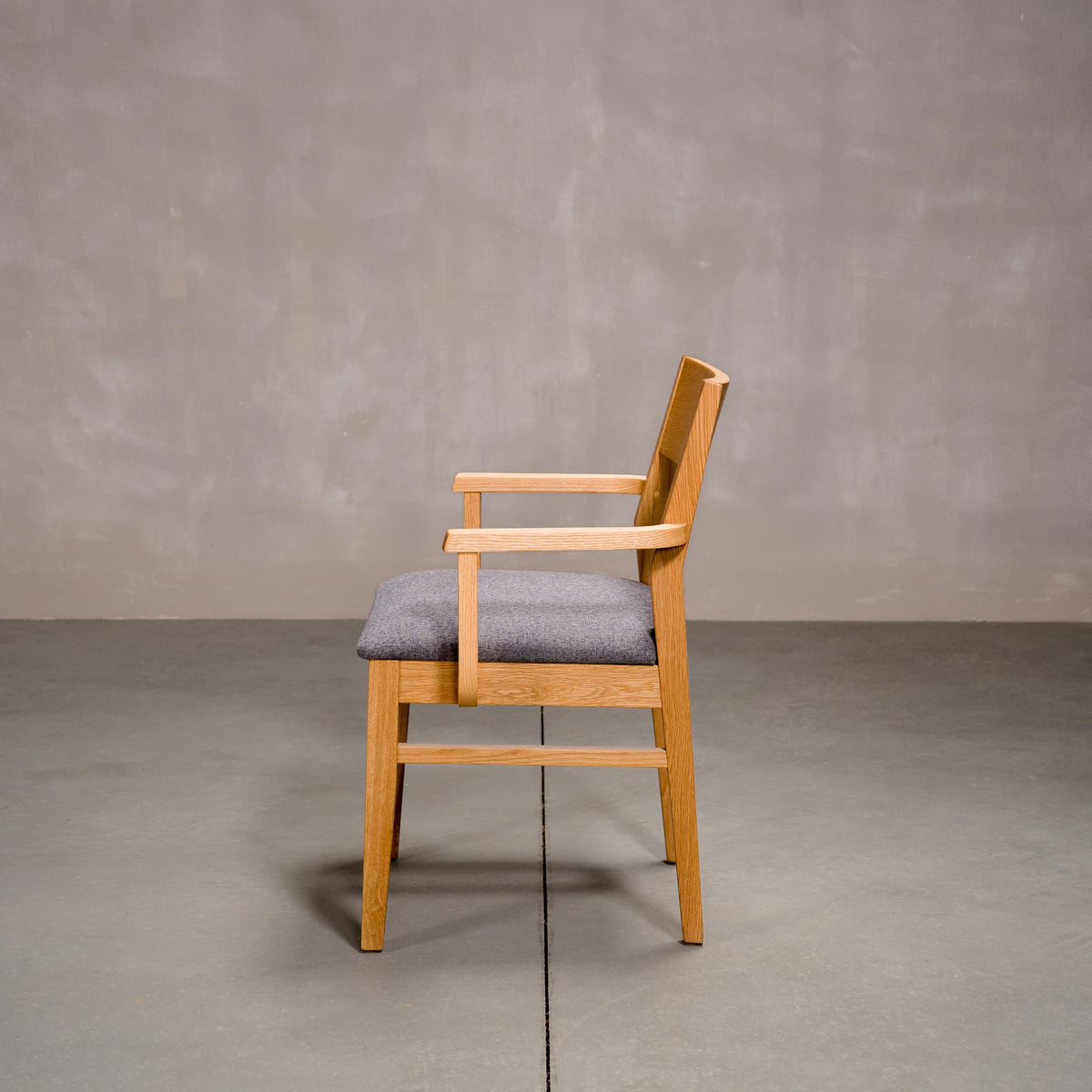 a White Oak Aubrey Armchair finished in Pure D with Graphite fabric seat