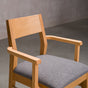 seat detail of a White Oak Aubrey Armchair finished in Pure D with Graphite fabric seat