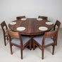 round dining table with Walnut chairs with fabric seats