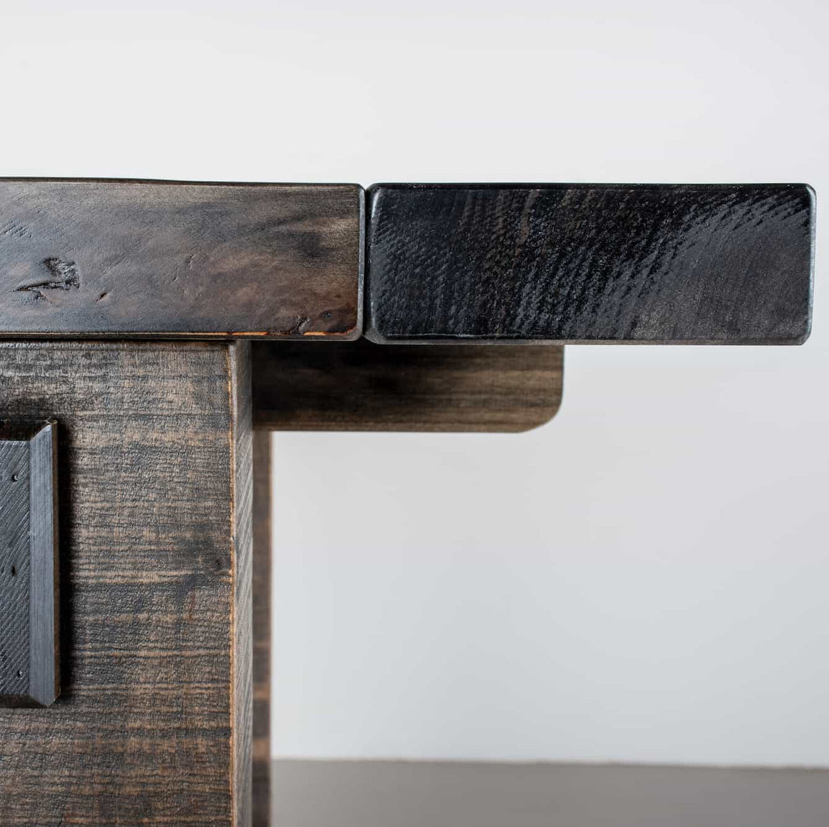 corner details of a rustic farmhouse table finished in smoke 42