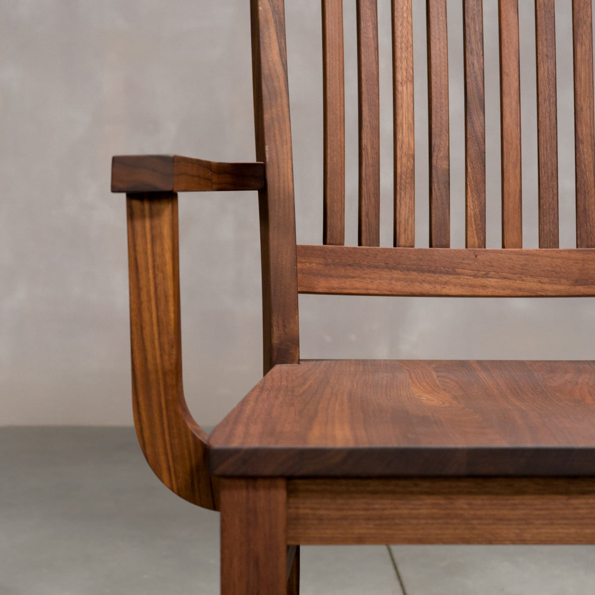 arm detail on a high back dining chair in Walnut