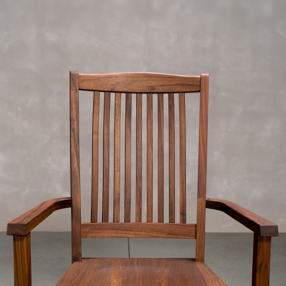 a high back dining chair with arms in Walnut