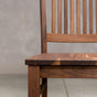 seat detail of a high back Betzner dining chair in Walnut