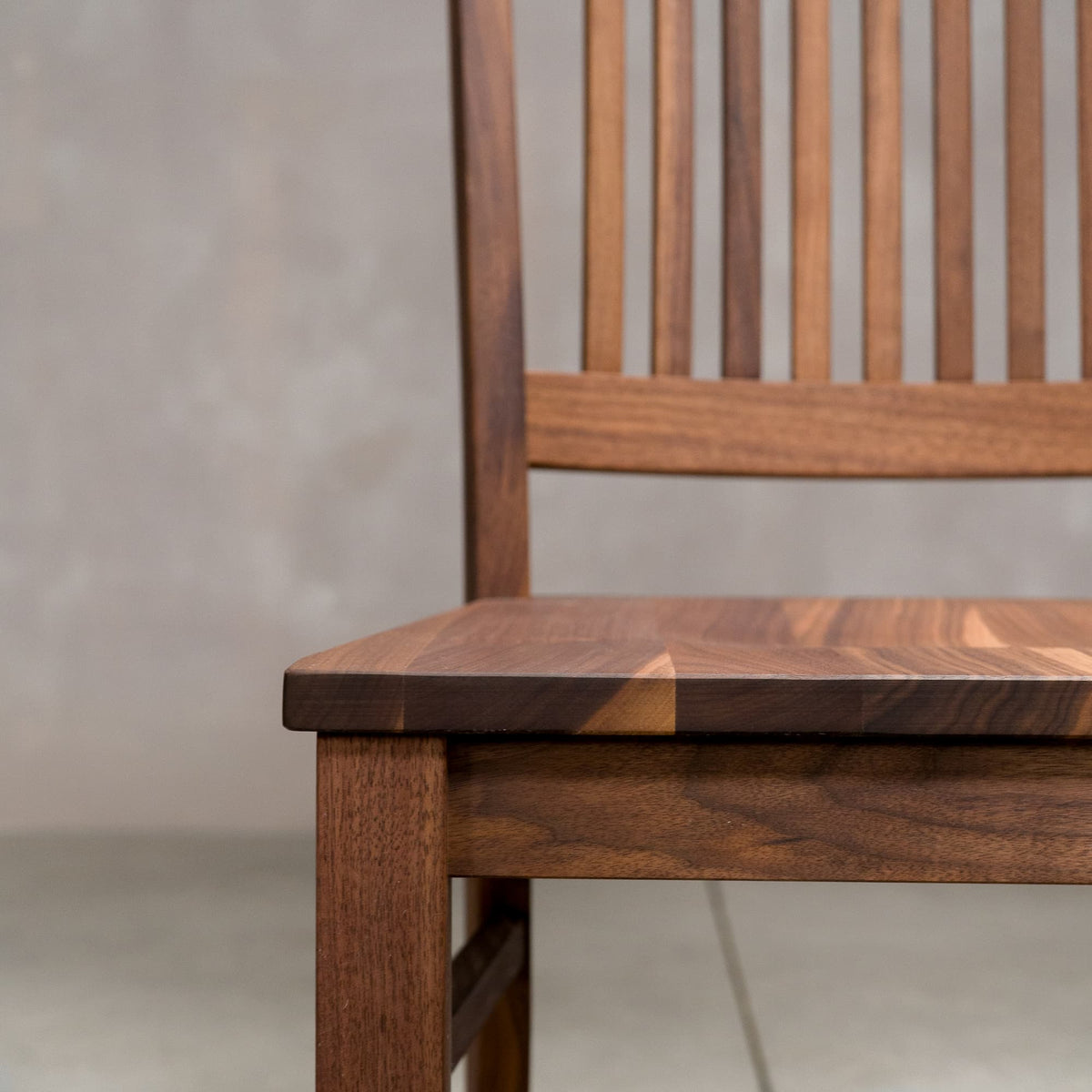 seat detail of a high back Betzner dining chair in Walnut