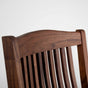 back detail of a high back walnut dining chair with arms
