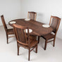 oval table with 4 high back walnut chair swith Walnut seats finished in Pure D
