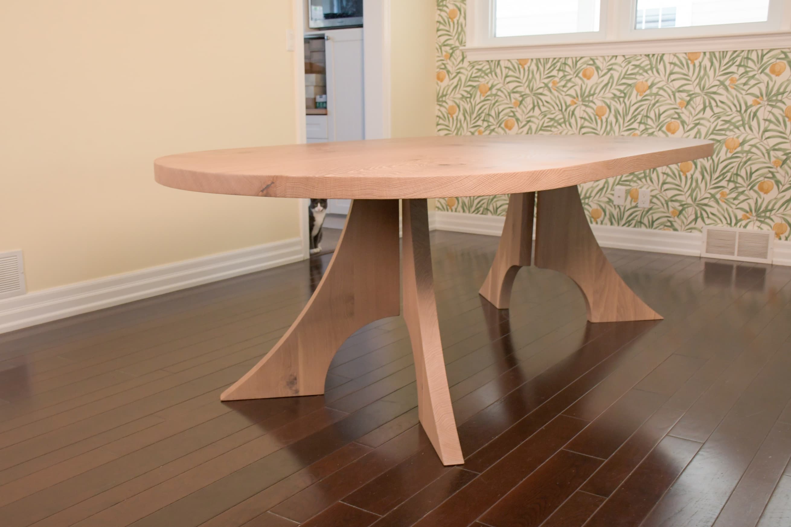Photo of a clear oak book matched racetrack dining table in a home