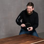 person playing ping pong on a custom walnut ping pong table 