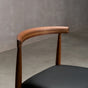 back detail of a midcentury modern Walnut dining chair with an Onyx Faux Leather seat