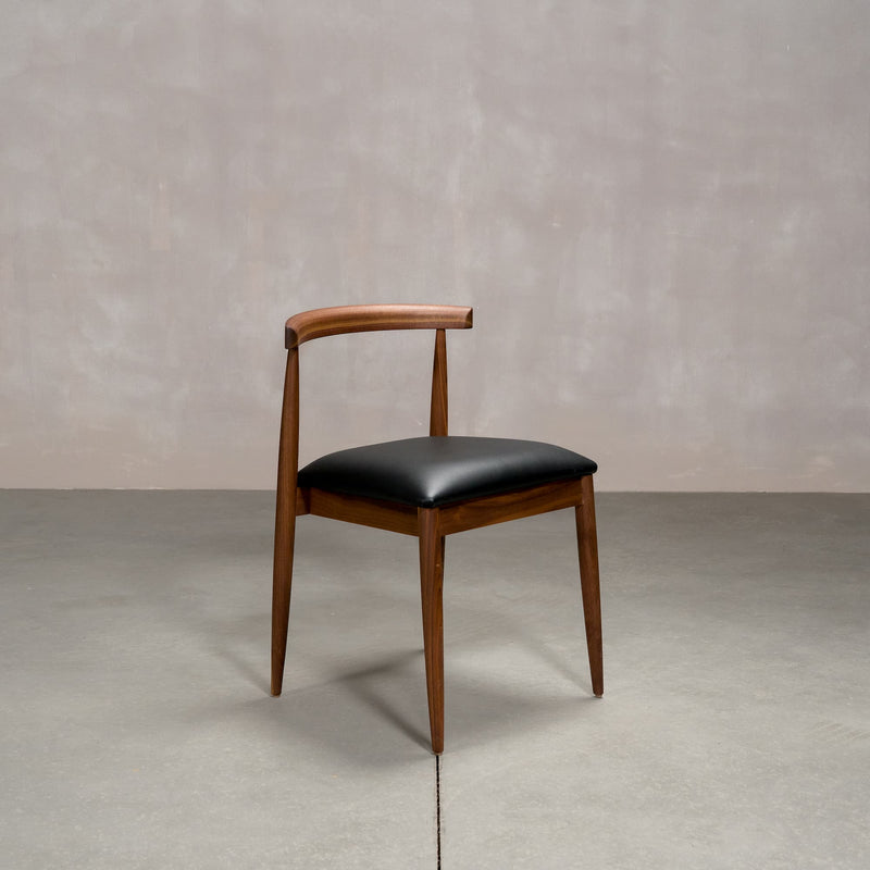midcentury modern Walnut dining chair with an Onyx Faux Leather seat