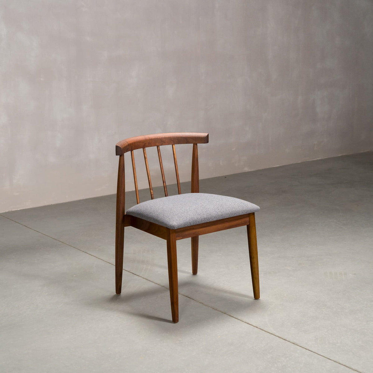 midcentury modern Walnut dining chair with back spindles and Graphite fabric seat