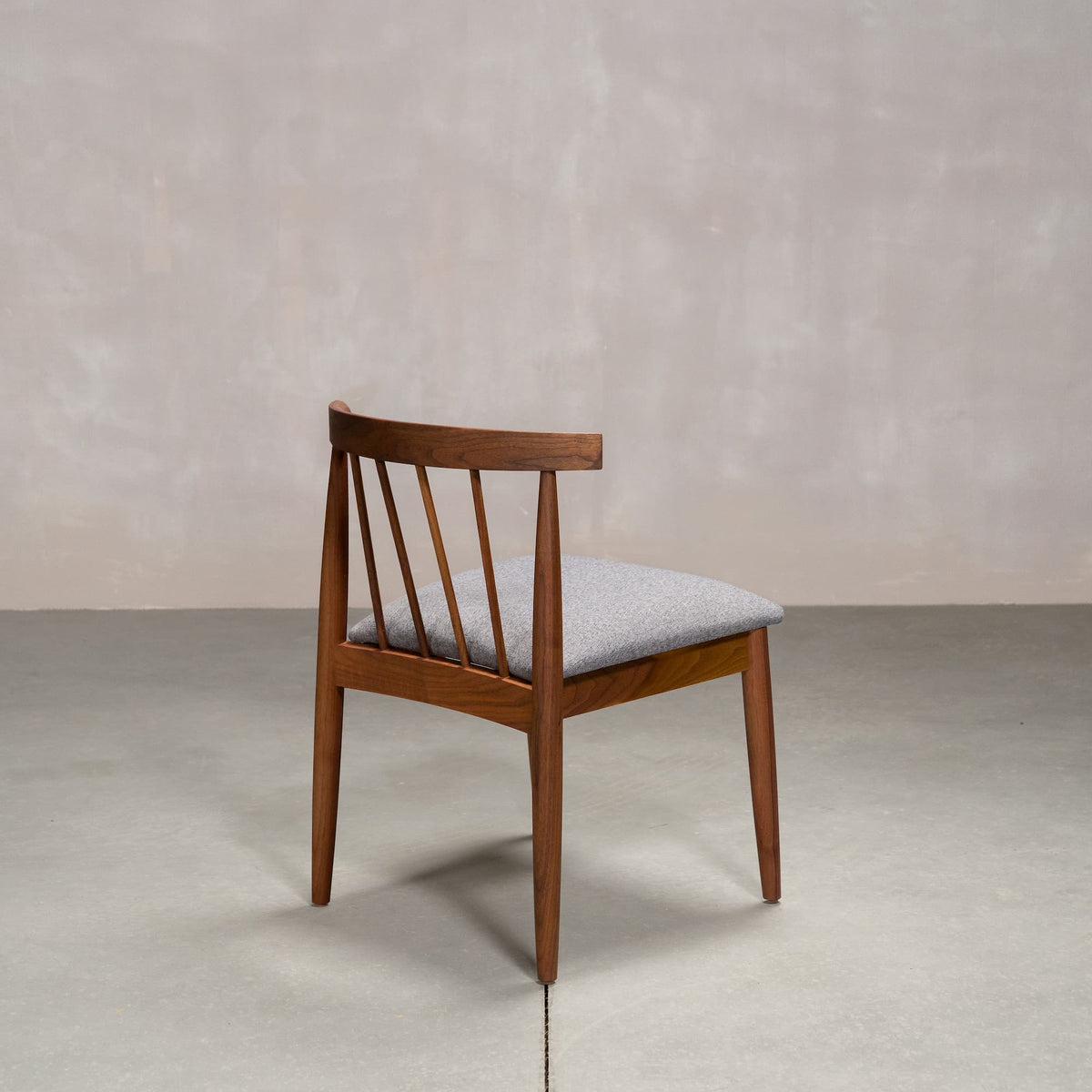 midcentury modern Walnut dining chair with back spindles and Graphite fabric seat