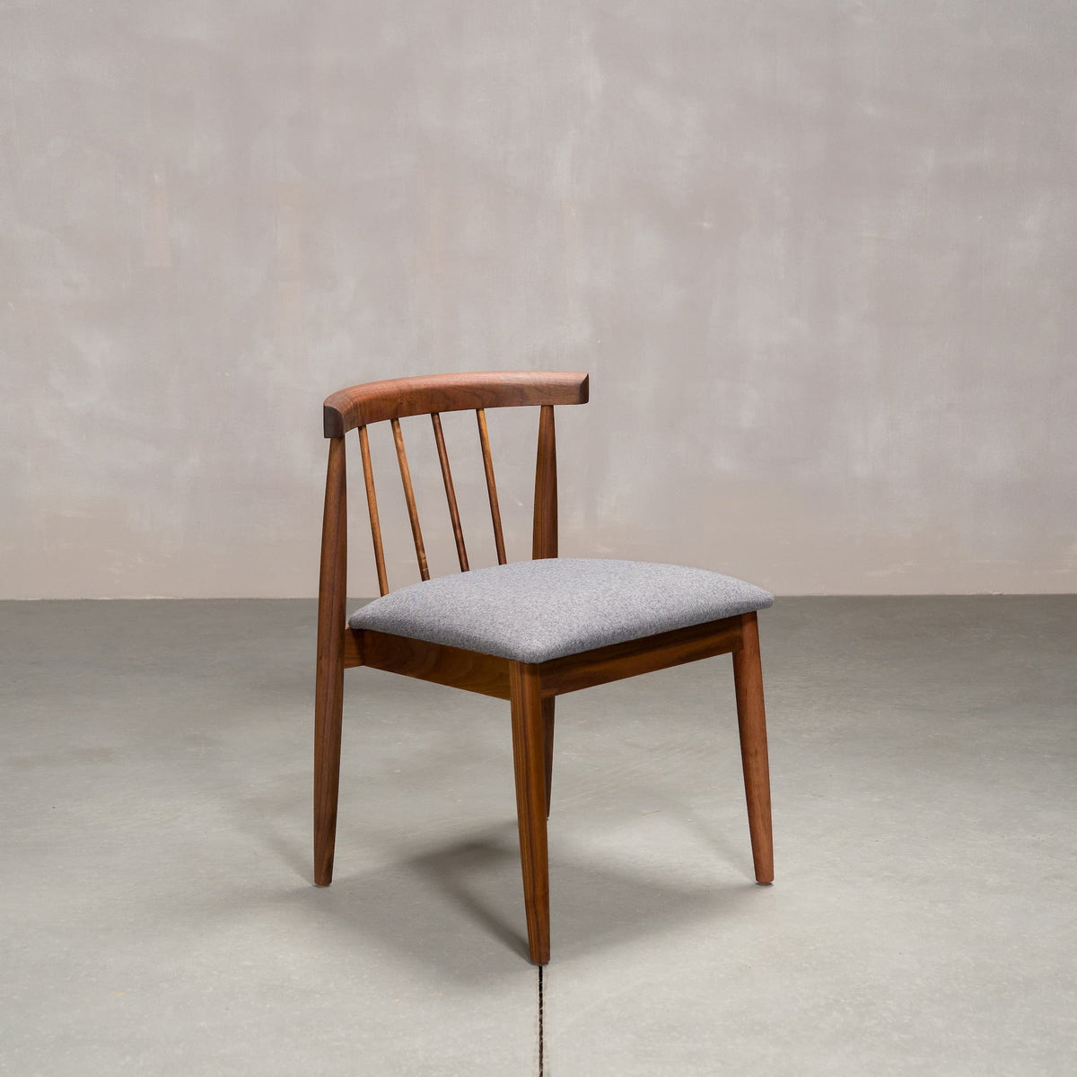 midcentury modern Walnut dining chair with back spindles and Graphite fabric seat