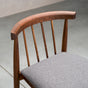 back detail of a midcentury modern Walnut dining chair with back spindles and Graphite fabric seat