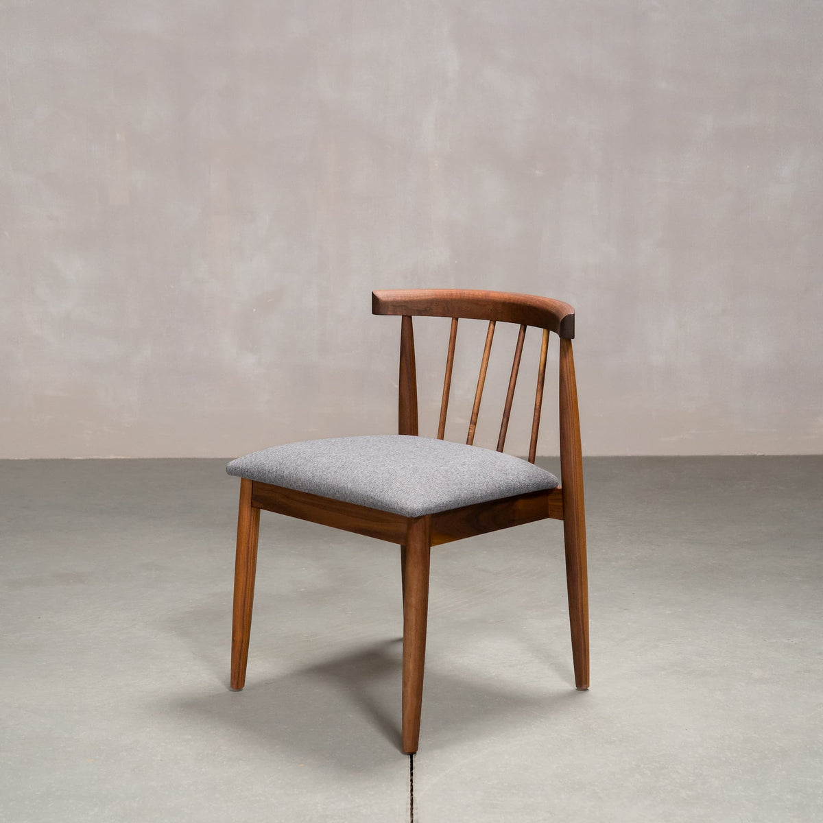 midcentury modern Walnut dining chair with back spindles and Graphite fabric seat