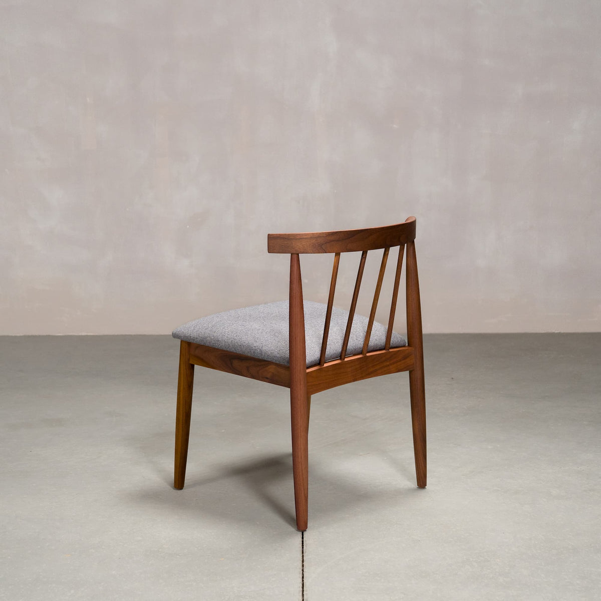 midcentury modern Walnut dining chair with back spindles and Graphite fabric seat