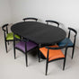 Oak table with a Black finish with 6 chairs finished in Black, each with a different color of faux leather seat