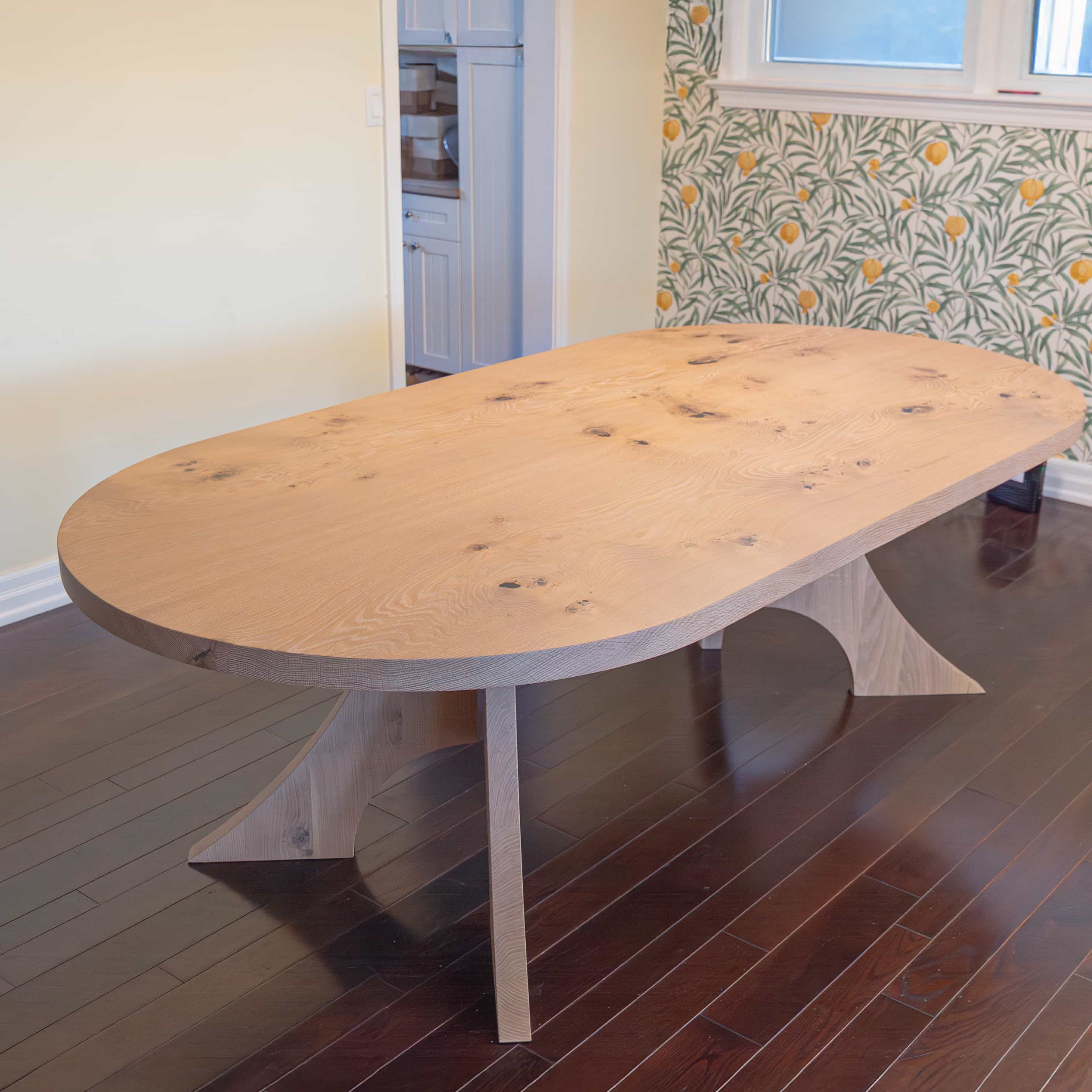 maple racetrack oval bookmatch table in a dining room