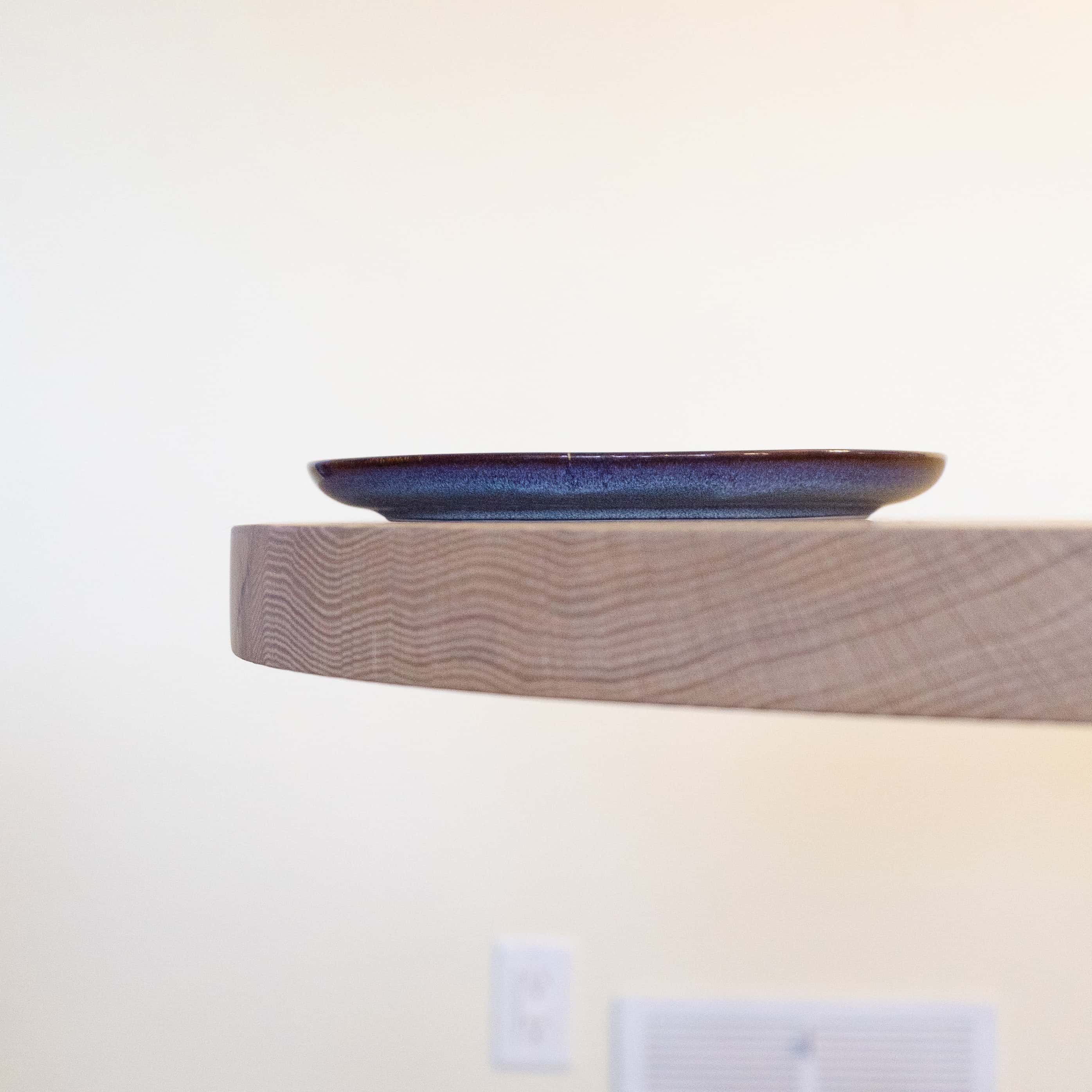 maple racetrack oval bookmatch table in a dining room, closeup of edge