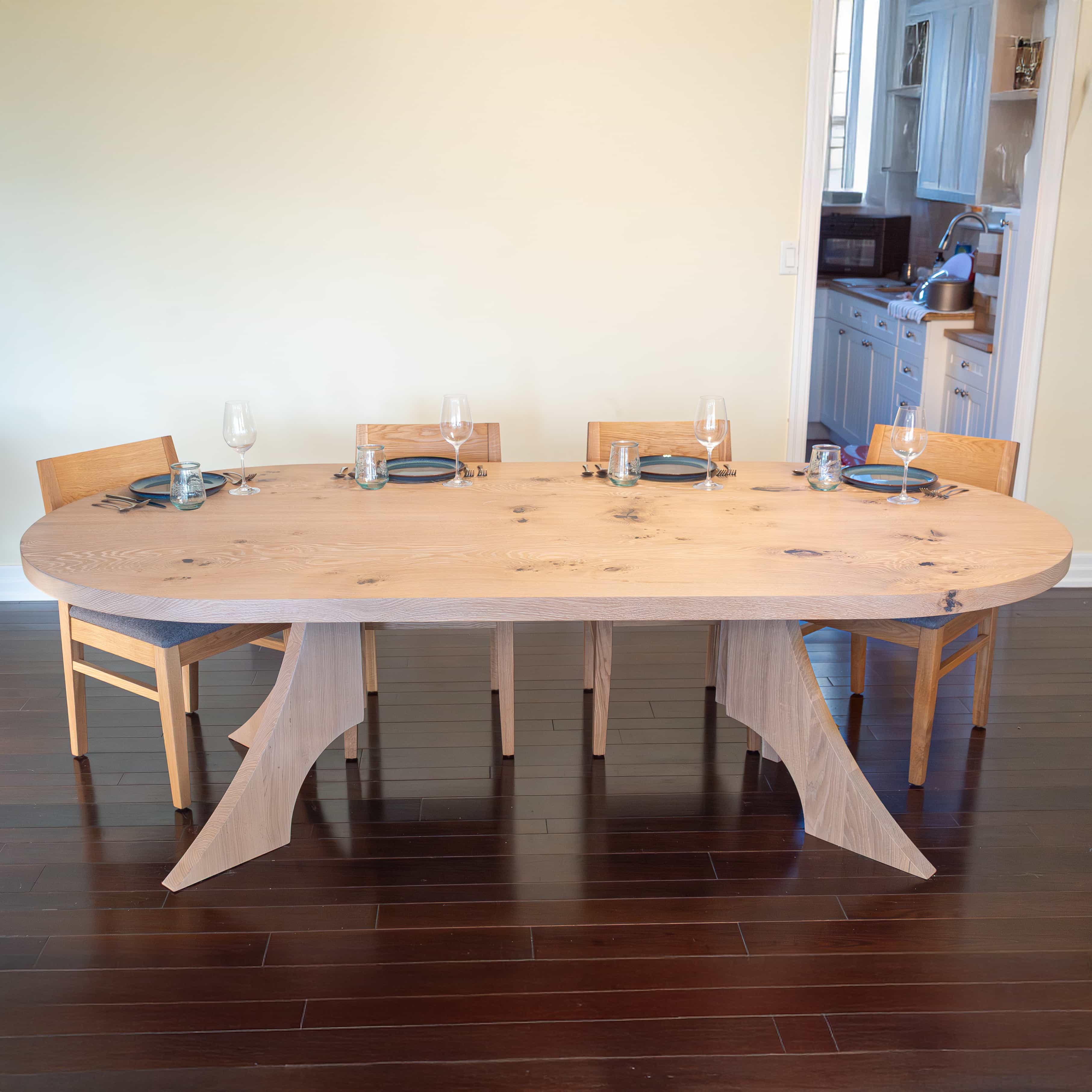 maple racetrack oval bookmatch table in a dining room