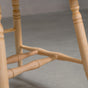 base detail on a hoop back dining chair with arms made of Maple with a Pure D finish