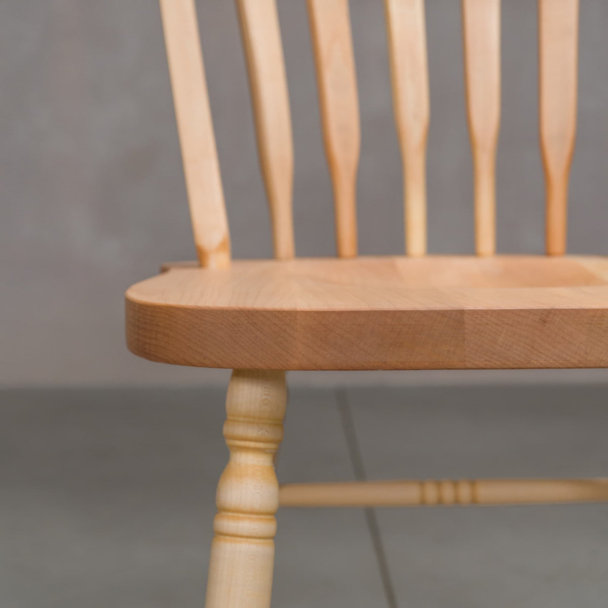 seat detail of a hoop back dining chair made of Maple with a Pure D finish