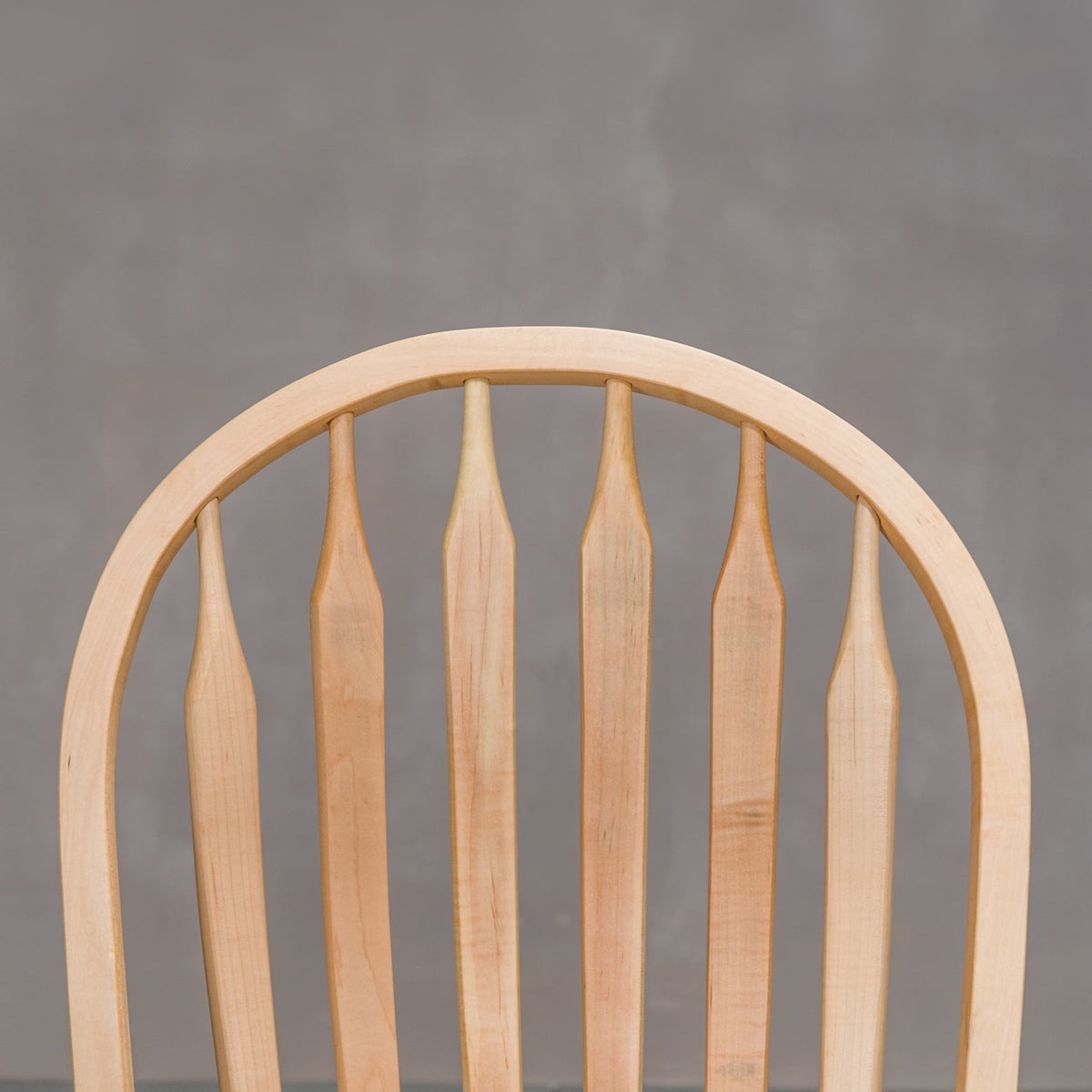 back detail of a hoop back dining chair made of Maple with a Pure D finish