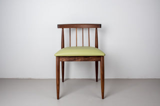 midcentury walnut dining chair with light green faux leather seat