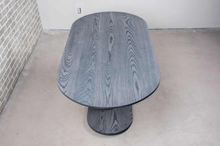 ash wood oval table on pedestal base finished in iron gray