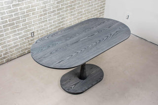 ash wood oval table on pedestal base finished in iron gray