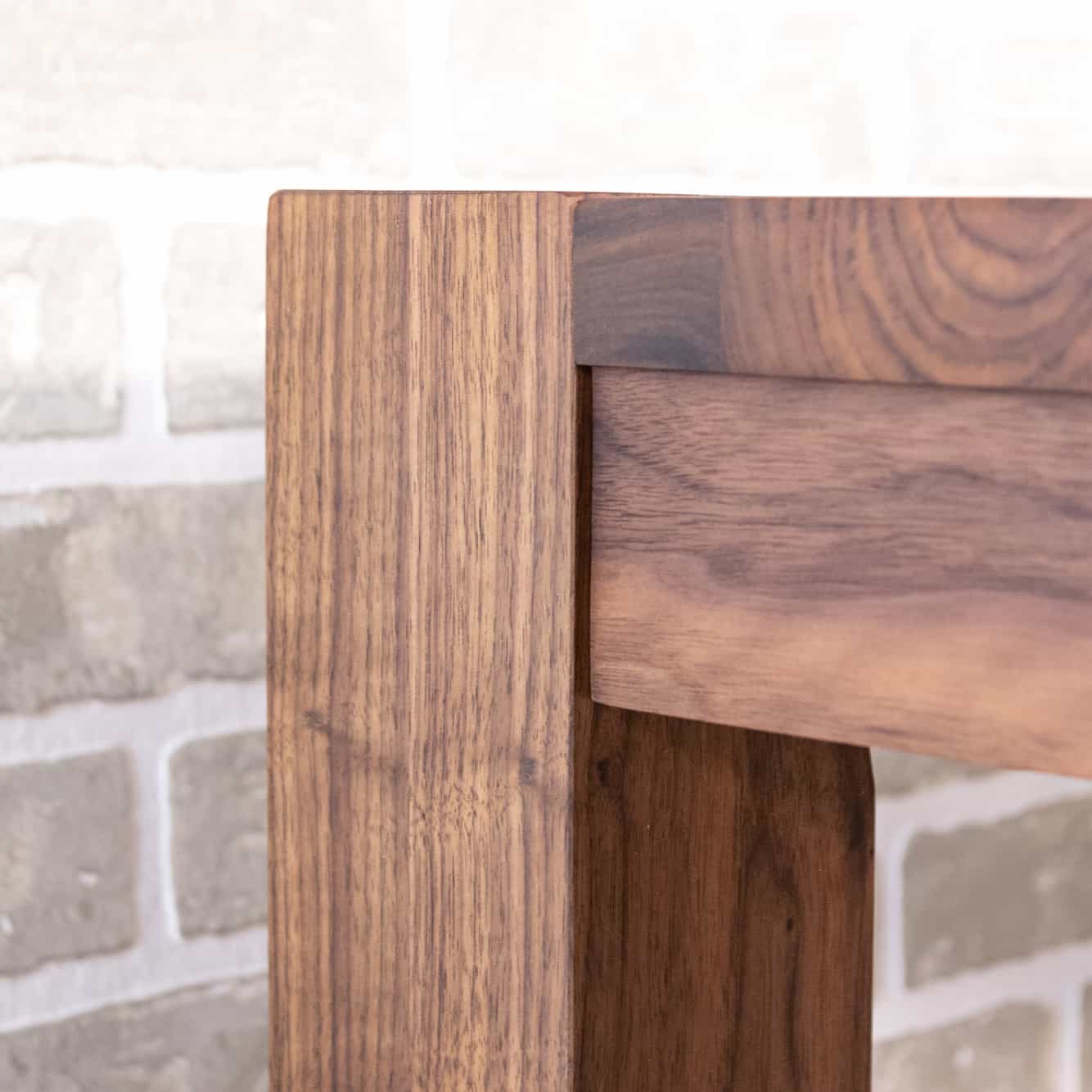 corner detail of modern walnut parsons table