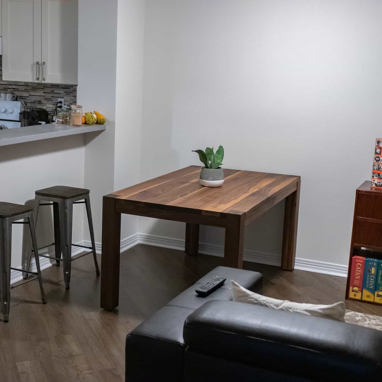 small modern walnut parsons table in an apartment