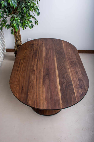 blackened walnut racetrack oval table on pedestal base