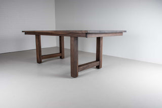 large extendable farmhouse table in blackened walnut on chunky H legs