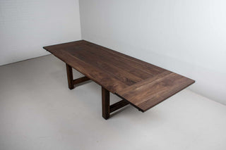 large extendable farmhouse table in blackened walnut on chunky H legs