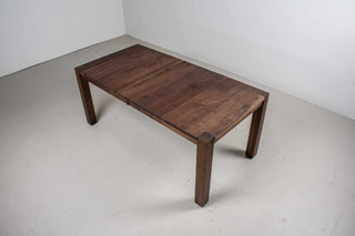 blackened walnut extendable table on modern exposed parsons base