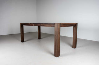 blackened walnut extendable table on modern exposed parsons base
