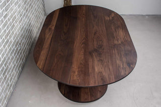 blackened walnut oval table on double pedestal base