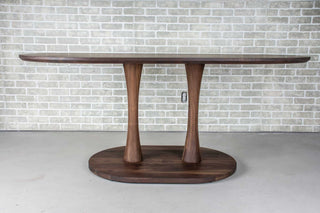 blackened walnut oval table on double pedestal base