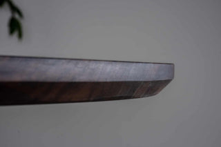 blackened walnut oval table on double pedestal base