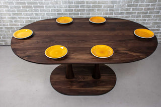blackened walnut oval table on double pedestal base
