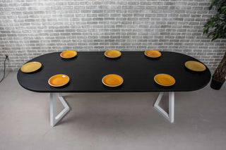 black oval oak dining table on white chevron legs