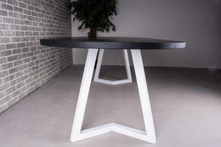 black oval oak dining table on white chevron legs