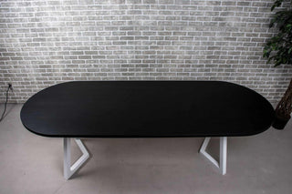 black oval oak dining table on white chevron legs