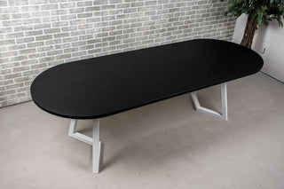 black oval oak dining table on white chevron legs