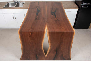 bar height bookmatch waterfall table in walnut attached to a counter